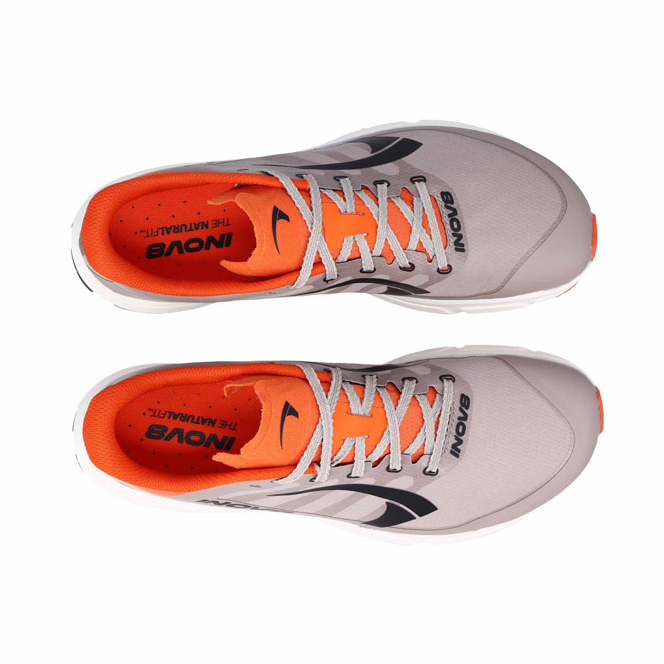 The uppers of a pair of INOV8 Women's TrailFly Pro Running Shoes in the Light Brown/Orange colourway.