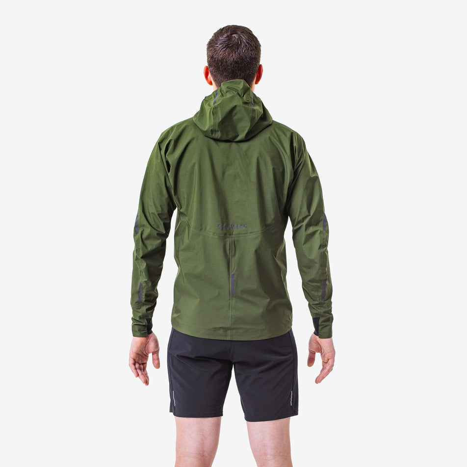 Back view of a model wearing a GOREWEAR Men's Concurve GORE-TEX Jacket in the Utility Green colourway. Model is also wearing GOREWEAR shorts. (8166448300194)
