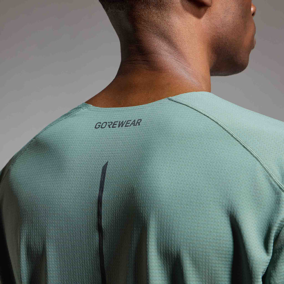 Back view of a model wearing the GOREWEAR Men's Contest 2.0 Tee in the Slate Green colourway.