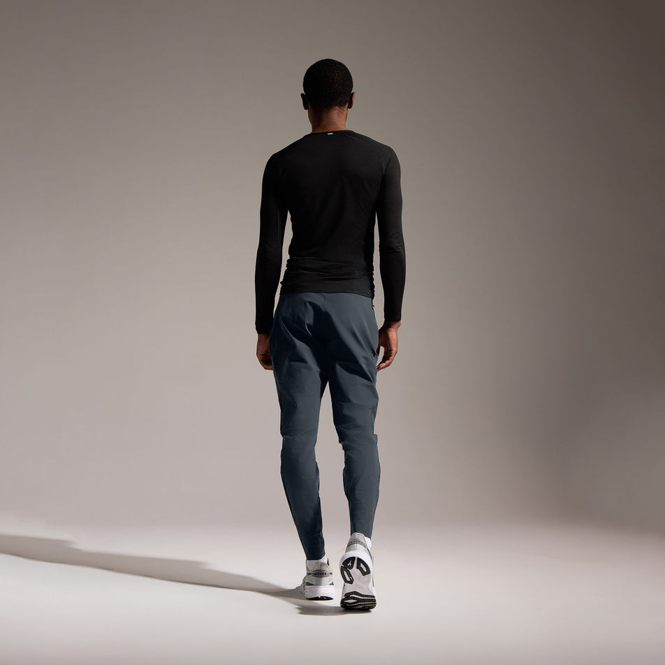 Back view of a model wearing the GOREWEAR Men's Everyday Track Pants in the Lab Graphite colourway. (8752076423330)