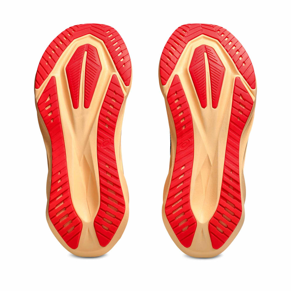 The outsoles of a pair of ASICS Men's Novablast 5 Running Shoes in the Midnight/Orange colourway. (8669077307554)