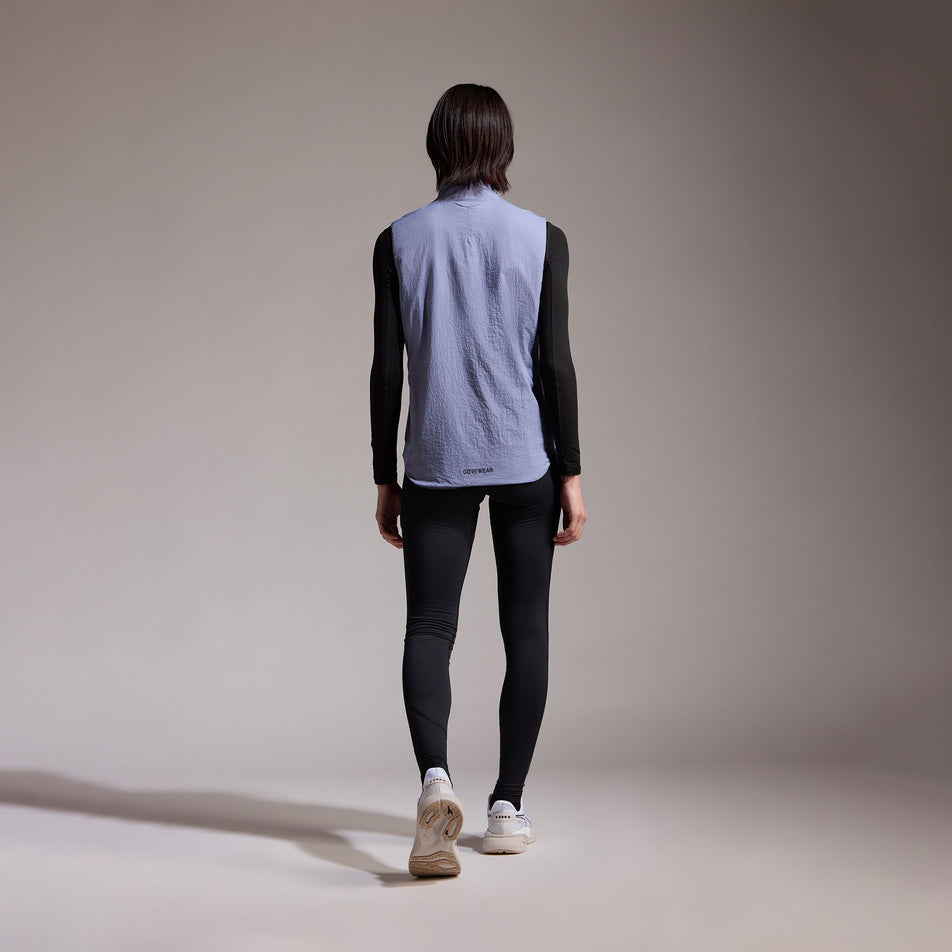 Back view of a model wearing the GOREWEAR Women's Concurve WINDSTOPPER Insulated Vest in the Amethyst Grey colourway. (8752085926050)