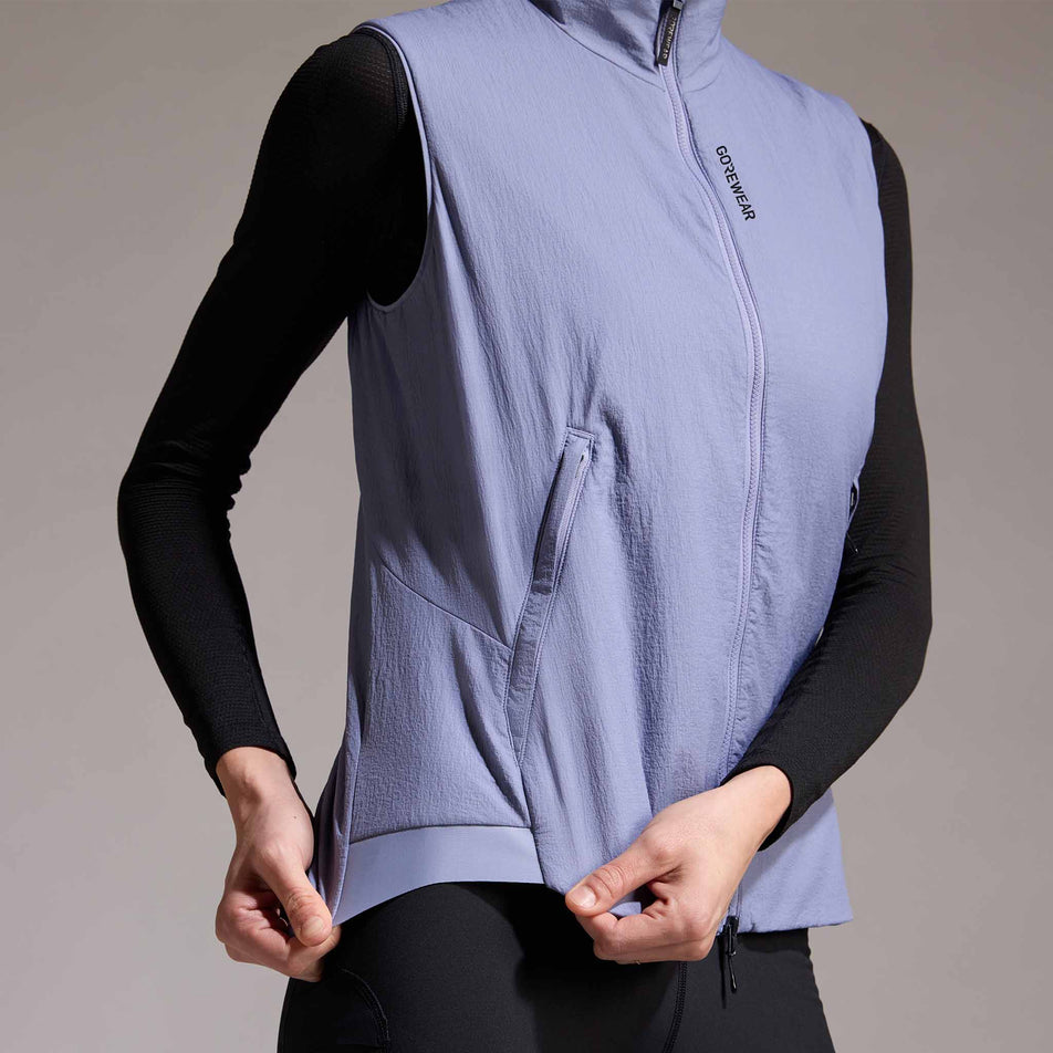 Front view of a model wearing the GOREWEAR Women's Concurve WINDSTOPPER Insulated Vest in the Amethyst Grey colourway. (8752085926050)