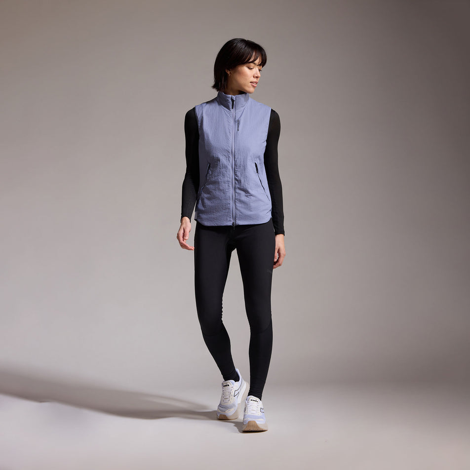 Front view of a model wearing the GOREWEAR Women's Concurve WINDSTOPPER Insulated Vest in the Amethyst Grey colourway. (8752085926050)