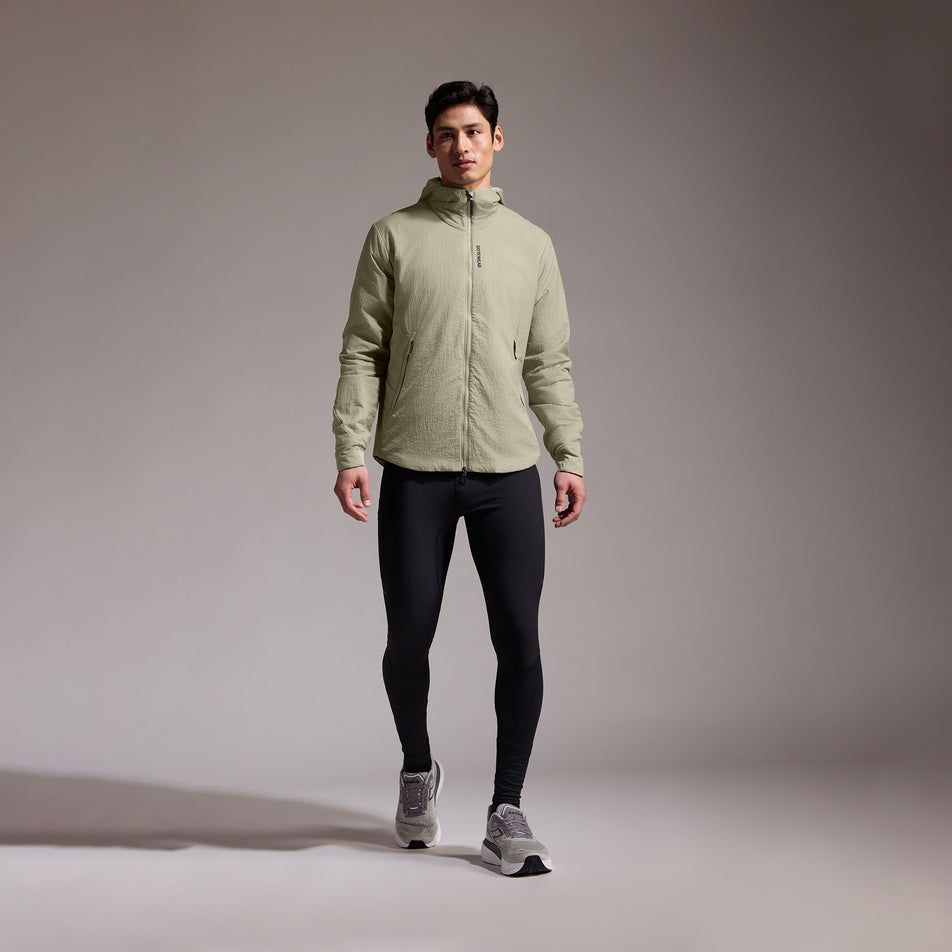 Front view of a model wearing the GOREWEAR Men's Concurve WINDSTOPPER Insulated Hooded Jacket in the Tech Beige colourway. (8751767945378)