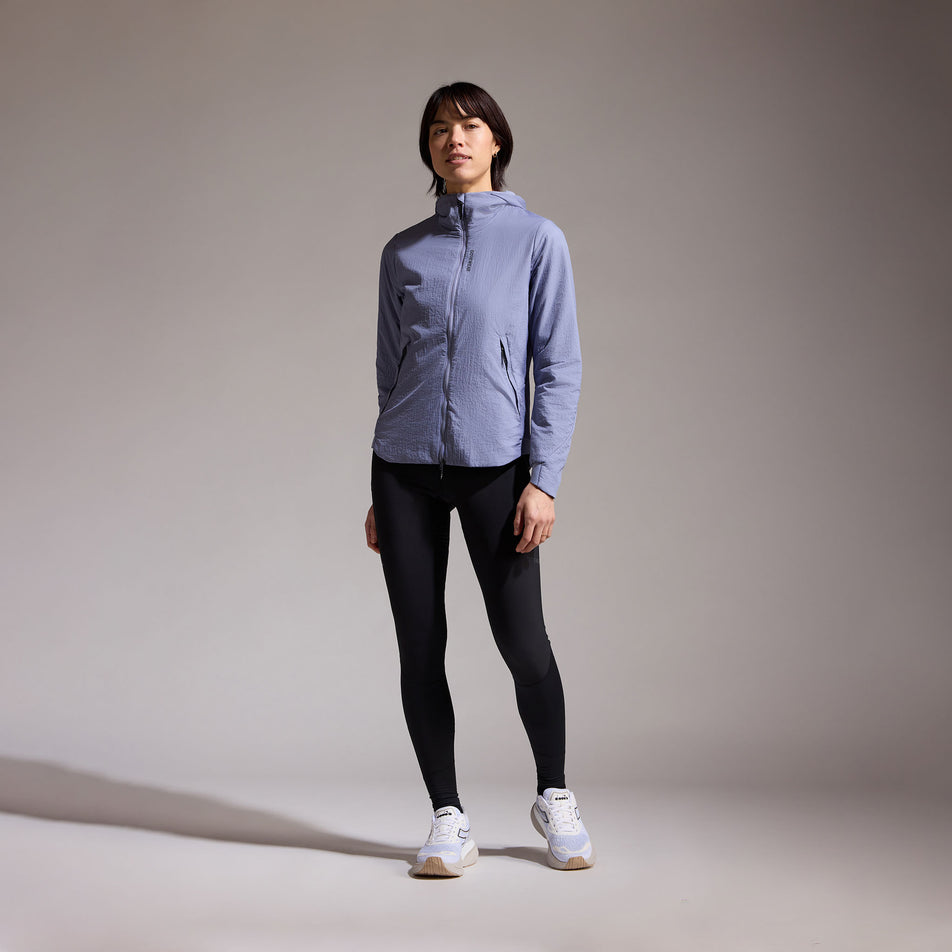 Front view of a model wearing the GOREWEAR Women's Concurve WINDSTOPPER Insulated Hooded Jacket in the Amethyst Grey colourway. (8752083796130)