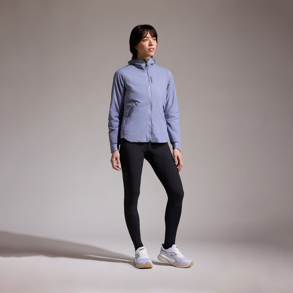 Front view of a model wearing the GOREWEAR Women's Concurve WINDSTOPPER Insulated Hooded Jacket in the Amethyst Grey colourway. (8752083796130)