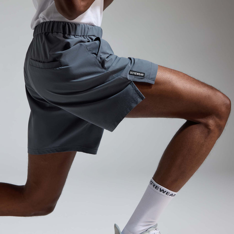 Side view of a model wearing the GOREWEAR Men's Training Shorts in the Lab Graphite colourway.
