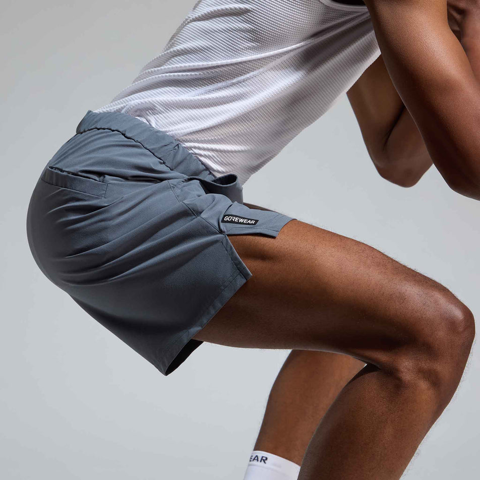 Side view of a model wearing the GOREWEAR Men's Training Shorts in the Lab Graphite colourway.