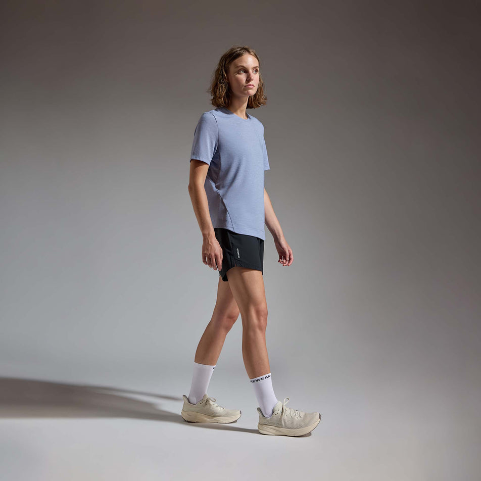 Angled view of a model wearing the GOREWEAR Women's Training Tee in the Amethyst Grey colourway.
