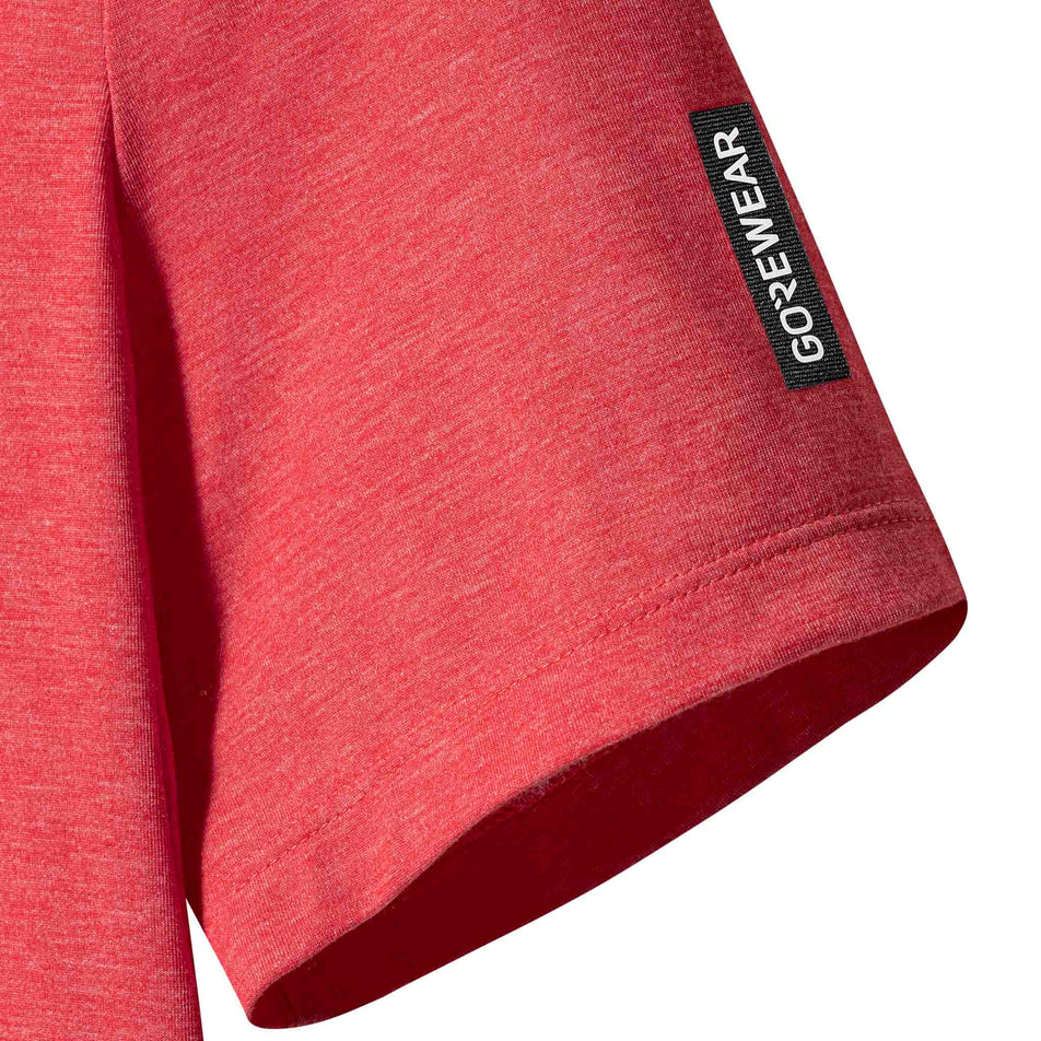Close-up view of the sleeve of the GOREWEAR Women's Training Tee in the Coral Red colourway.