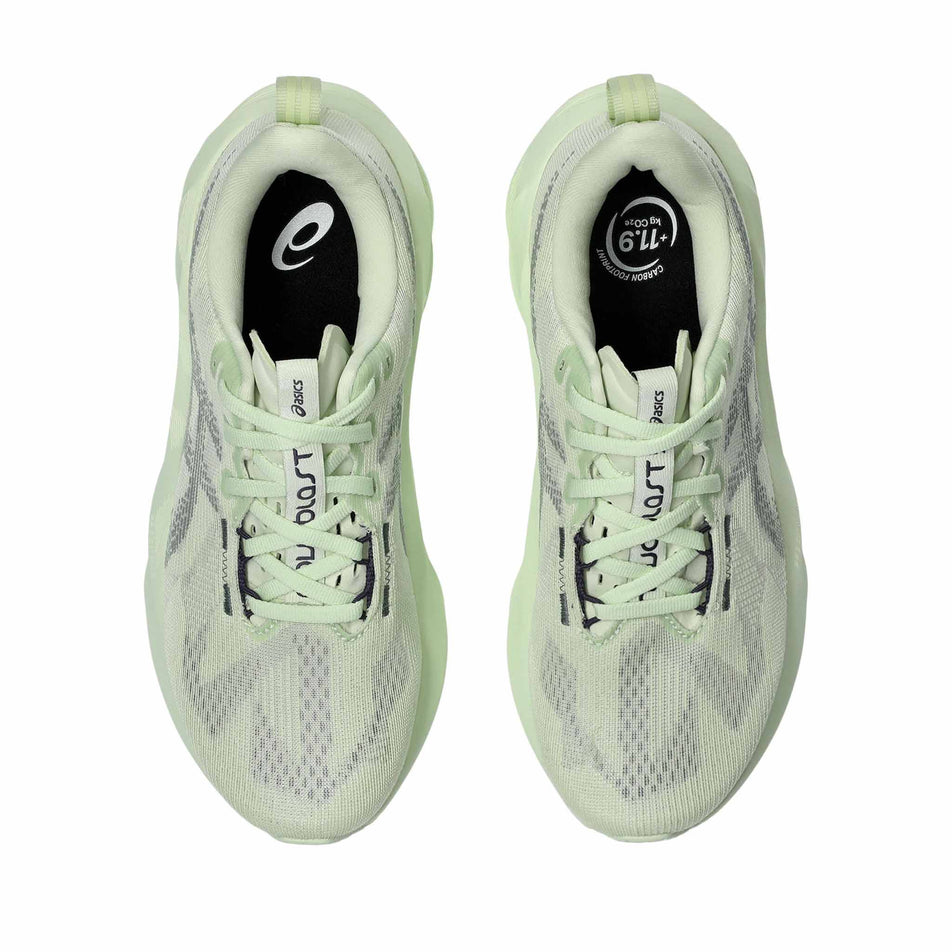 The uppers of a pair of ASICS Women's Novablast 5 Running Shoes in the Whisper Green/Monument colourway. (8669097984162)