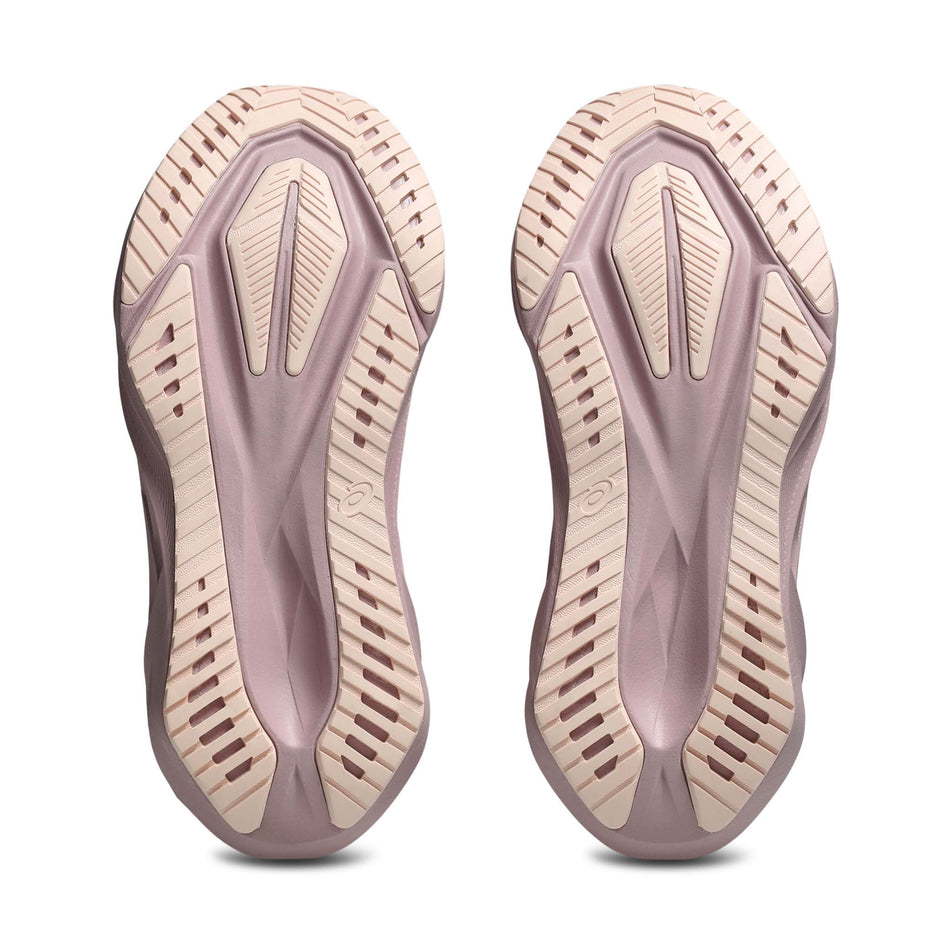 The outsoles of a pair of ASICS Women's Novablast 5 Running Shoes in the Pearl/Morganite colourway.