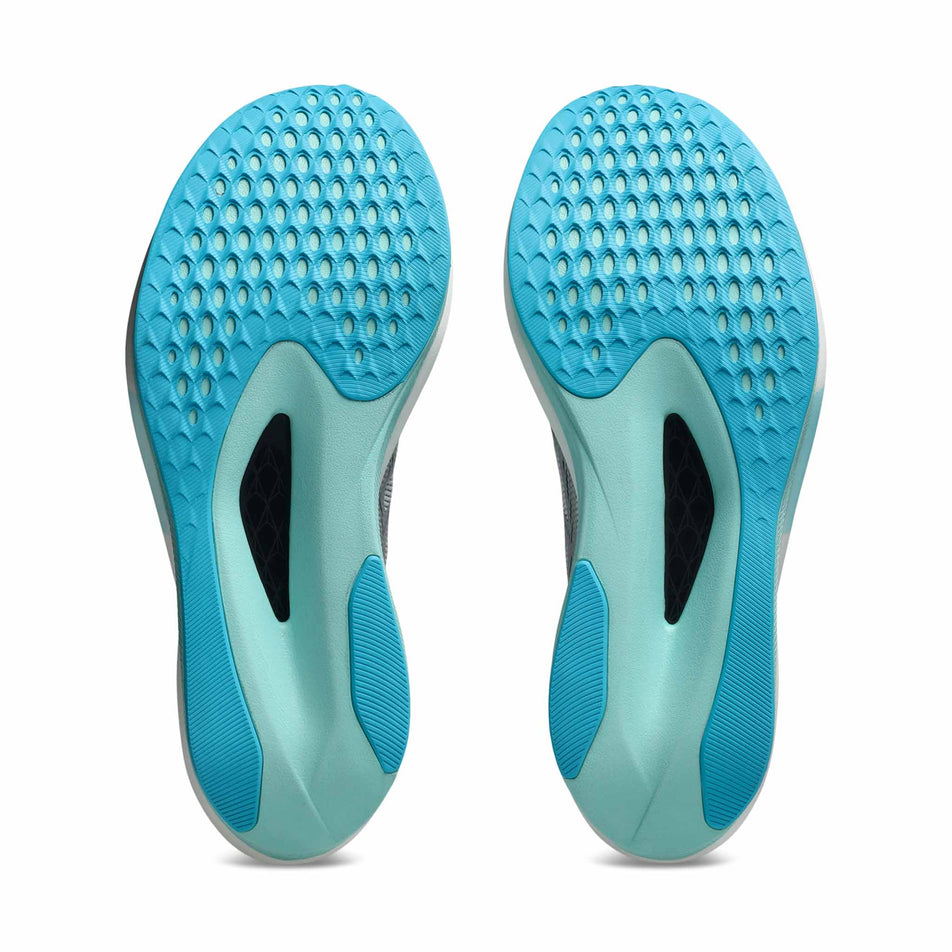 The outsoles of a pair of ASICS Unisex Magic Speed 5 Running Shoes in the White/Pure Silver colourway.