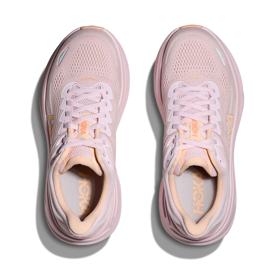 The uppers of a pair of HOKA Women's Bondi 9 Running Shoes in the Lilac Cream/Tangerine Glow colourway.