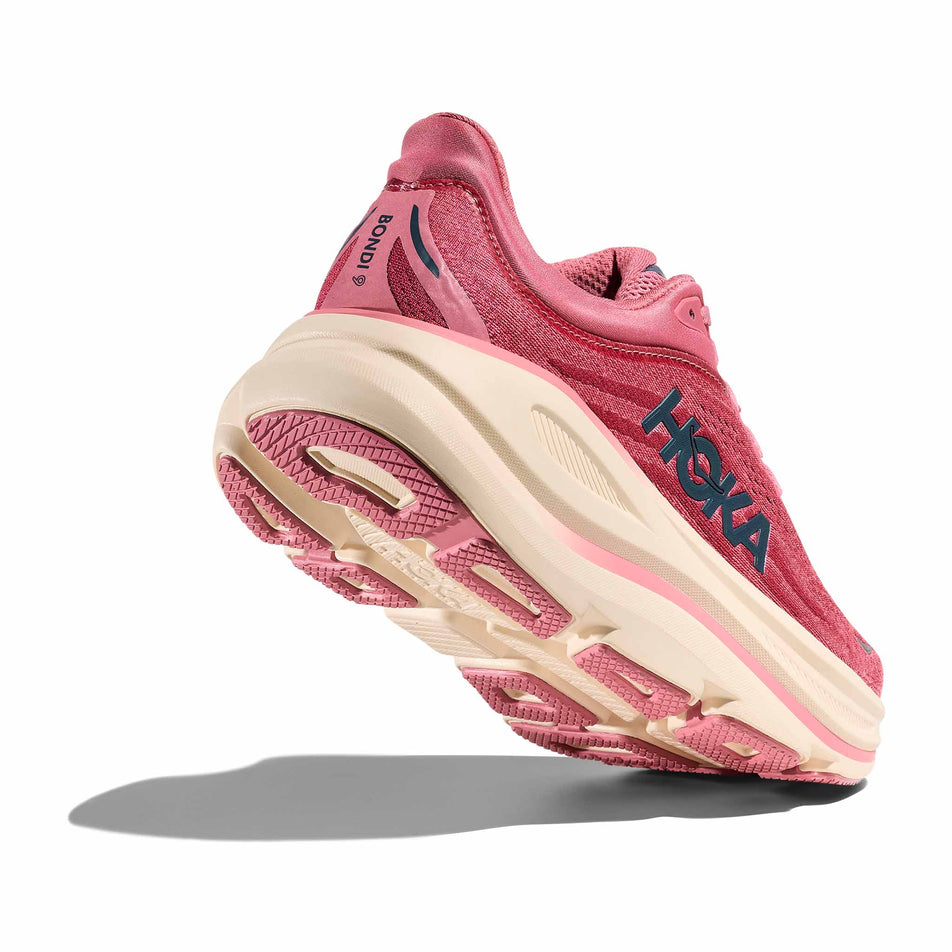 Lateral - and outsole - view of the right shoe from a pair of HOKA Women's Bondi 9 Running Shoes in the Lingonberry/Cranberry colourway.
