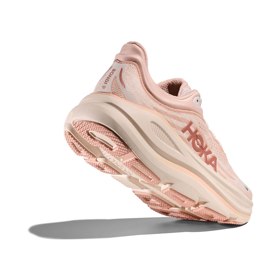 Lateral - and outsole - view of the right shoe from a pair of HOKA Women's Bondi 9 Running Shoes in the Rose Latte/Rose Cream colourway. (8689288937634)
