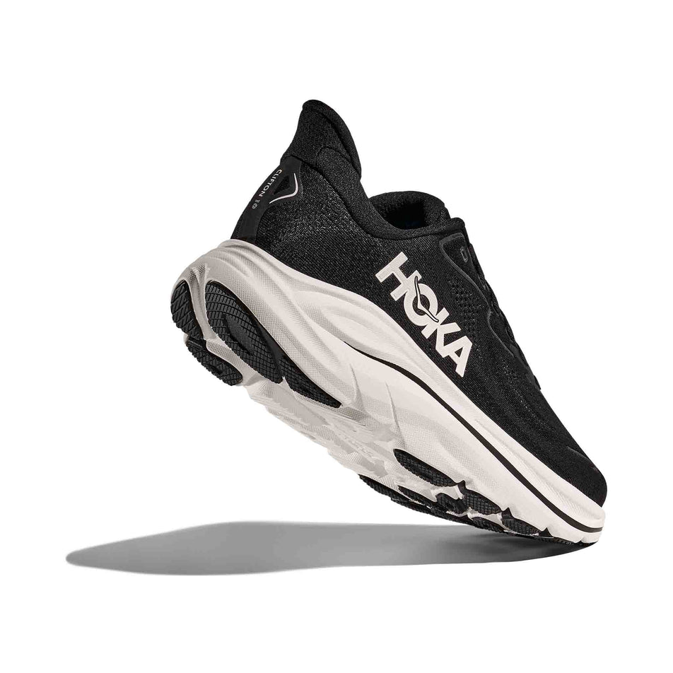 Lateral view - and outsole - of the right shoe from a pair of HOKA Women's Clifton 10 Running Shoes in the Black/White colourway. (8637752115362)