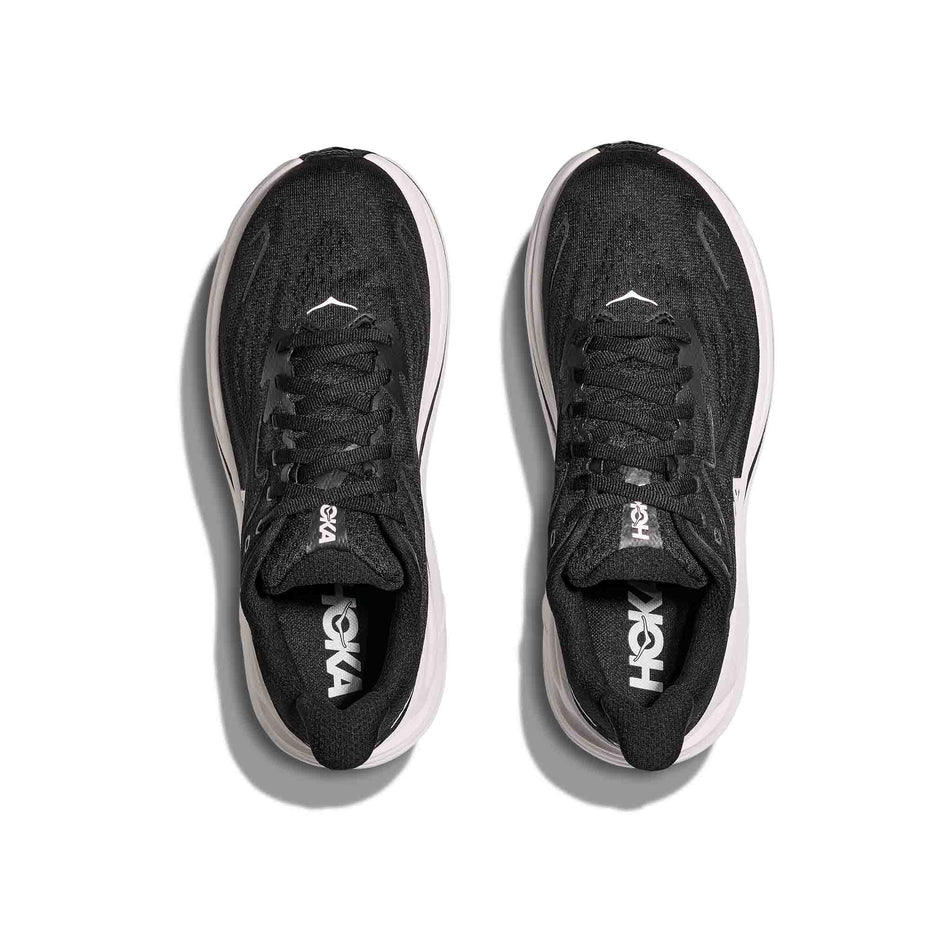 The uppers of a pair of HOKA Women's Clifton 10 Running Shoes in the Black/White colourway. (8637752115362)