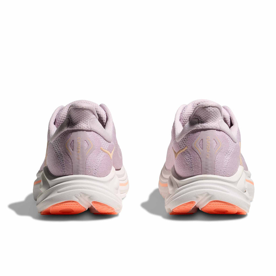 The back of a pair of HOKA Women's Clifton 10 Running Shoes in the Lilac Cream/Tangerine Glow colourway.