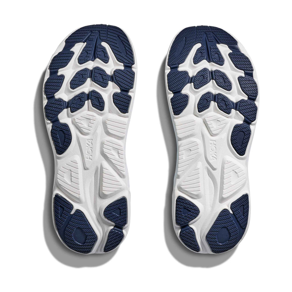 The outsoles of a pair of HOKA Women's Clifton 10 Running Shoes in the Soaring Blue/Frost colourway.