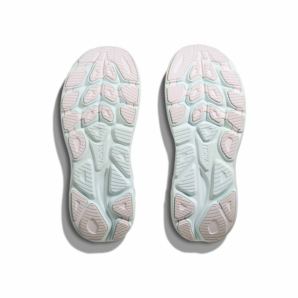 The outsoles of a pair of HOKA Women's Clifton 10 Running Shoes in the White/Cielo Blue colourway. (8637769875618)