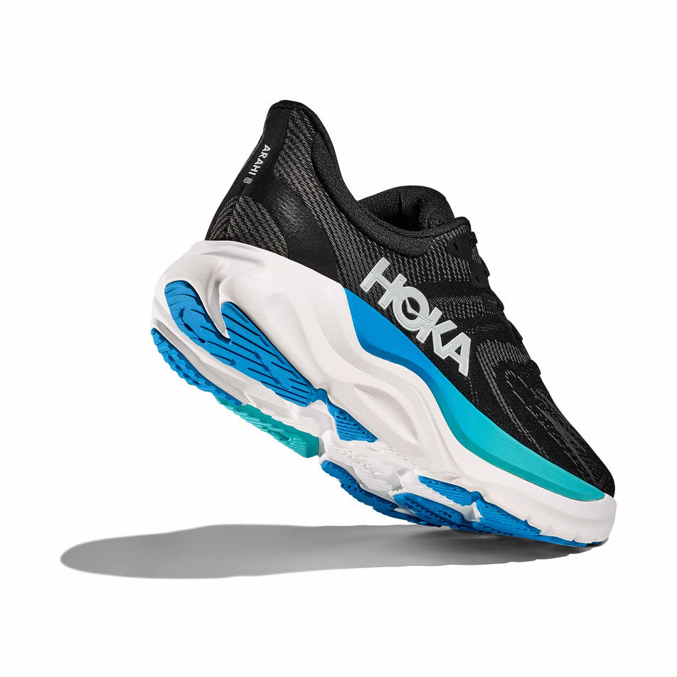 Lateral - and outsole - view of the right shoe from a pair of HOKA Men's Arahi 8 Running Shoes in the Black/Skyward Blue colourway. (8689208328354)