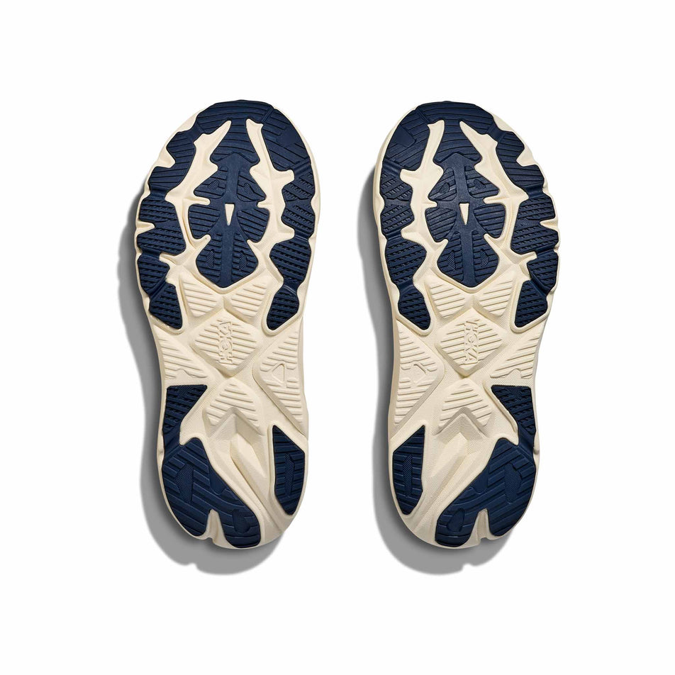 The outsoles of a pair of HOKA Women's Arahi 8 Running Shoes in the Rose Cream/Alabaster colourway. (8689326129314)