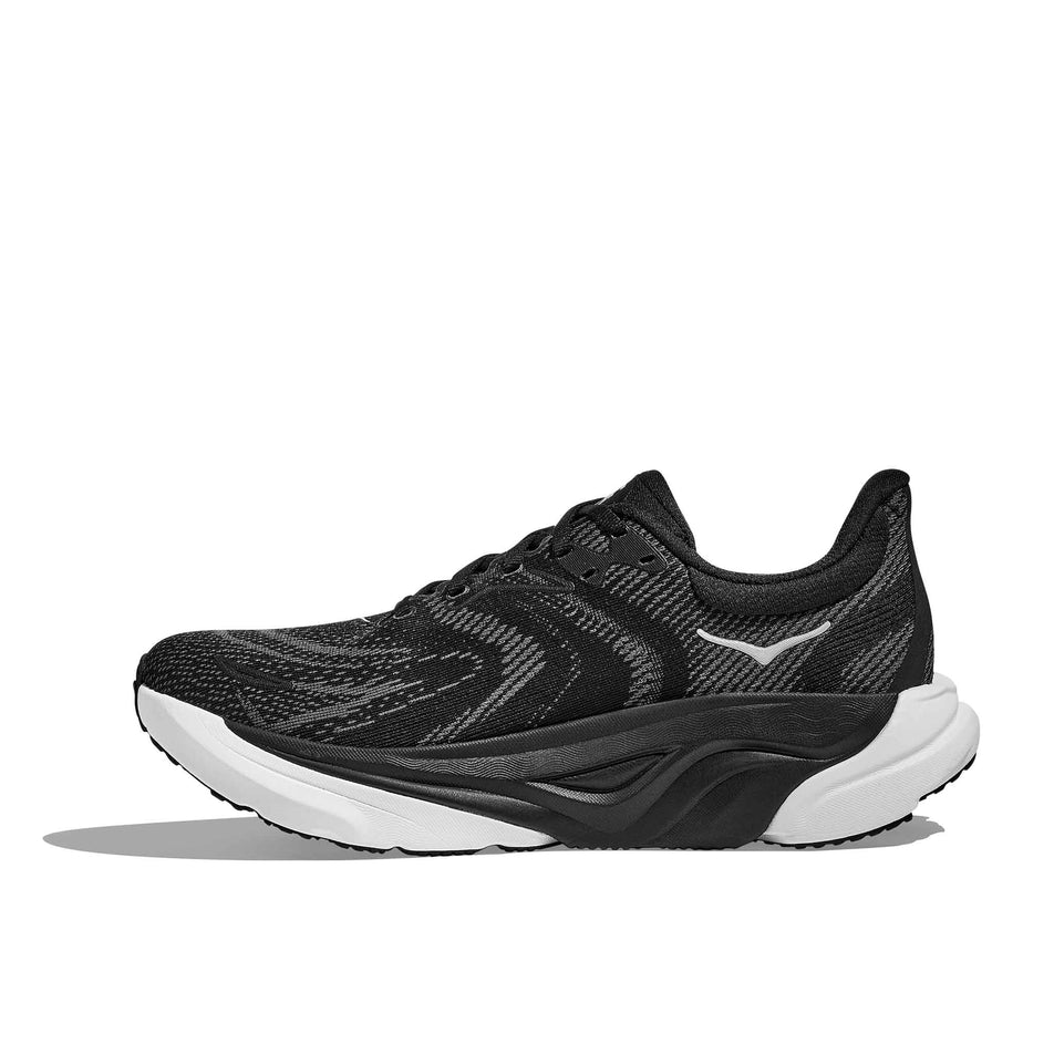 Medial view of the right shoe from a pair of HOKA Women's Arahi 8 Wide Running Shoes in the Black/White colourway. (8689328947362)
