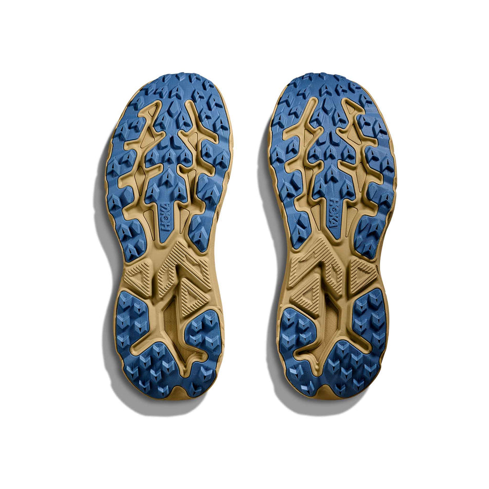 The outsoles of a pair of HOKA Men's Challenger 8 Running Shoes in the Maple/Cardamom colourway. (8689254105250)