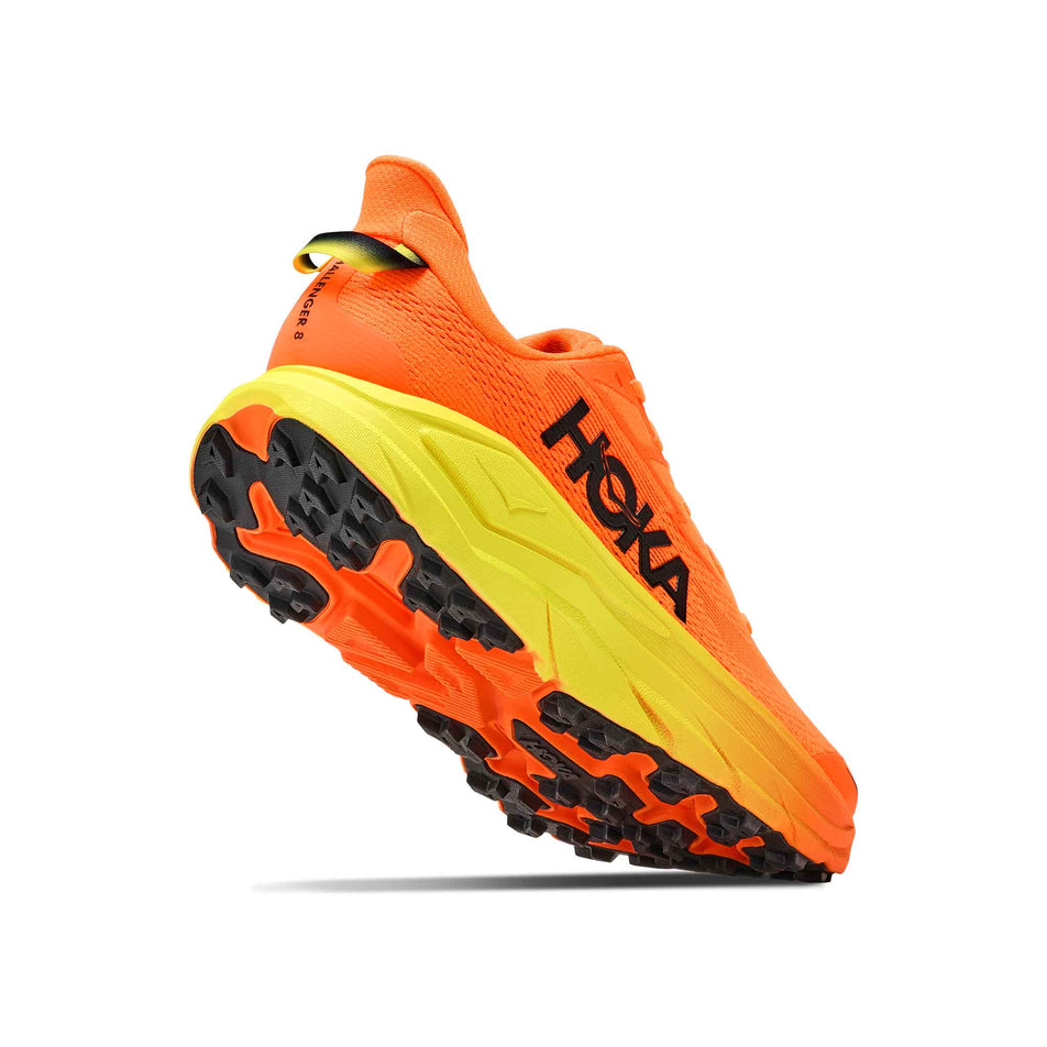 Lateral - and outsole - view of the right shoe from a pair of HOKA Men's Challenger 8 Running Shoes in the Neon Tangerine/Hoka Citrus colourway.
