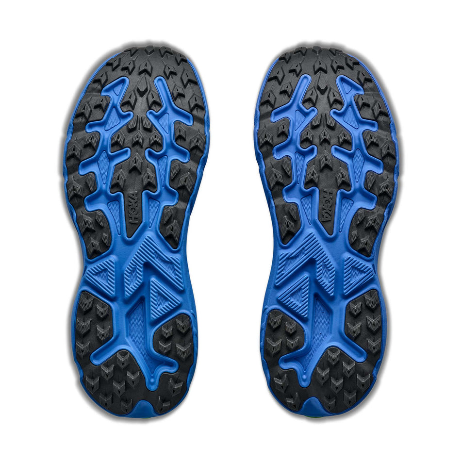 The outsoles of a pair of HOKA Men's Challenger 8 Running Shoes in the Stardust/Virtual Blue colourway.