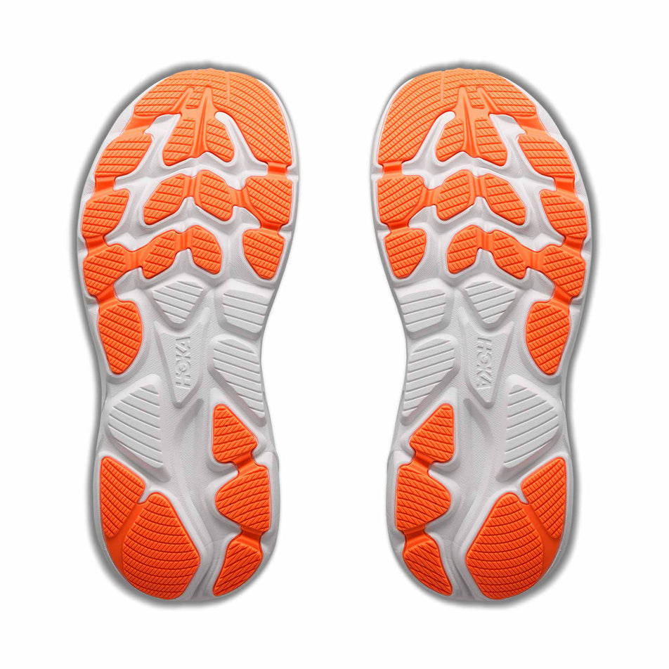 The outsoles of a pair of HOKA Clifton 10 Big Kids Running Shoes in the Night Glow Blue/Electric Aqua colourway.
