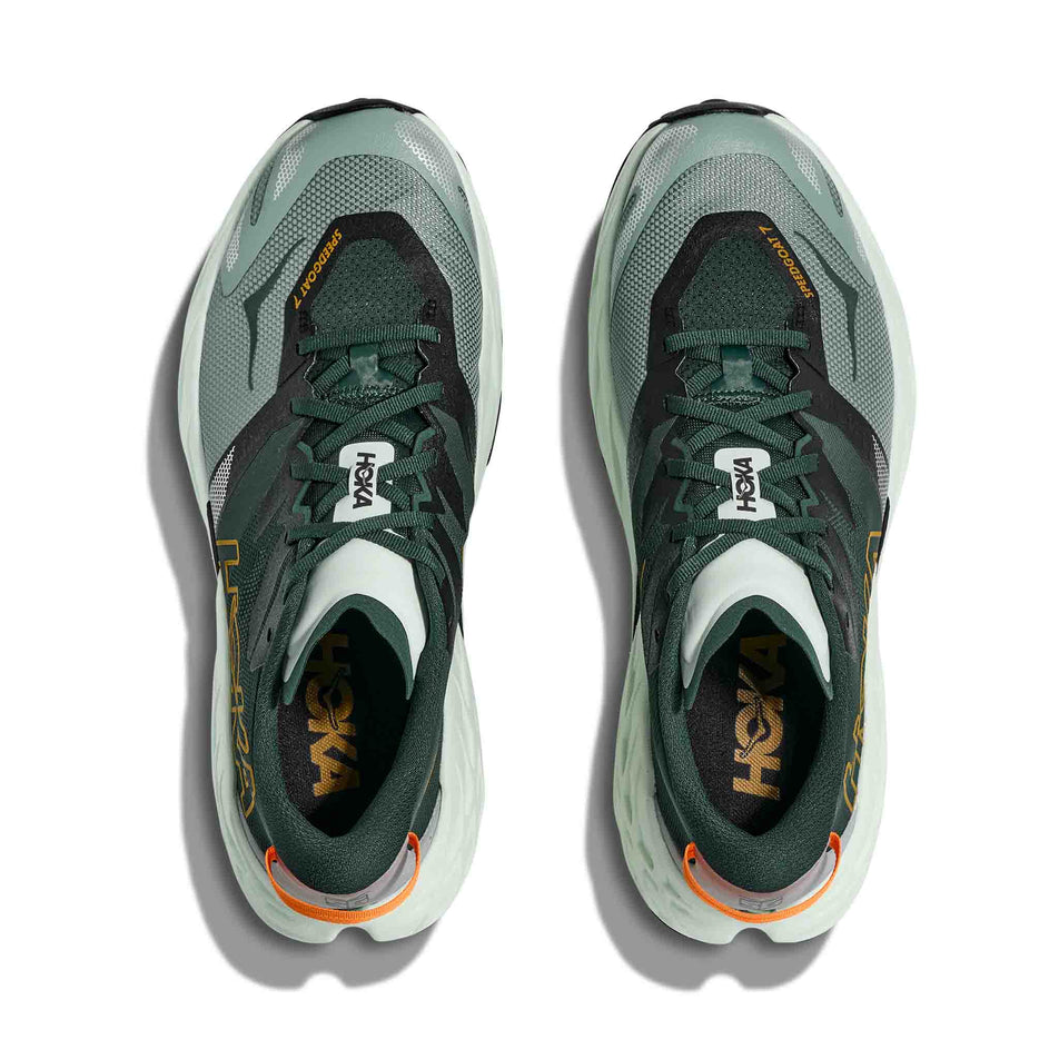 The uppers of a pair of HOKA Men's Speedgoat 7 Running Shoes in the Bay Leaf/Sea Glass colourway.