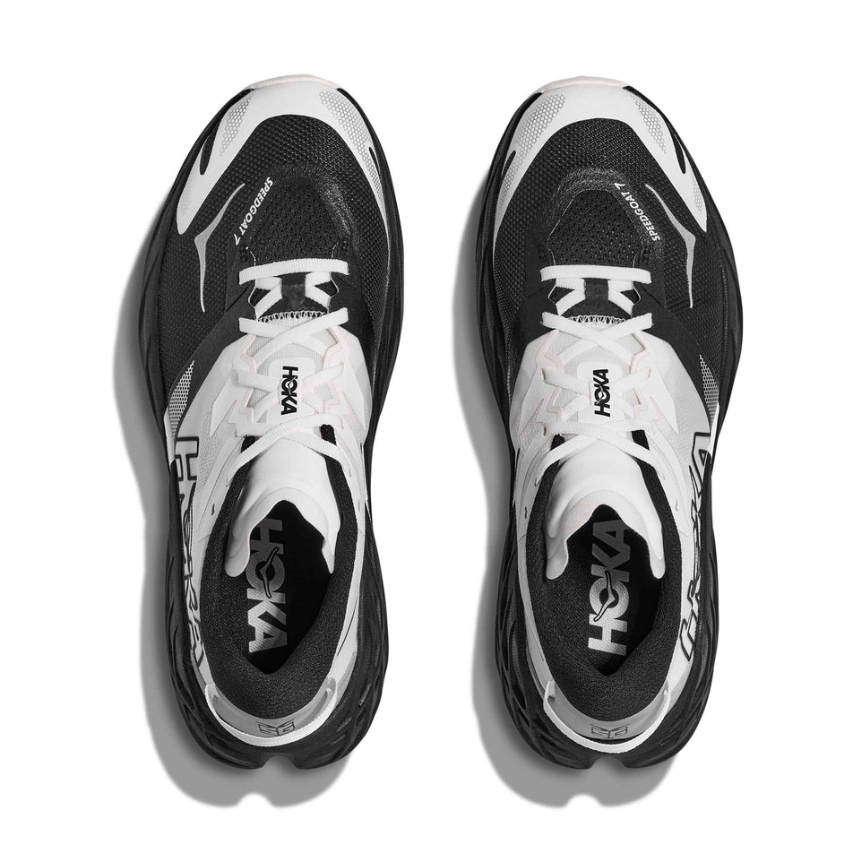 The uppers of a pair of HOKA Women's Speedgoat 7 Running Shoes in the Black/White colourway.