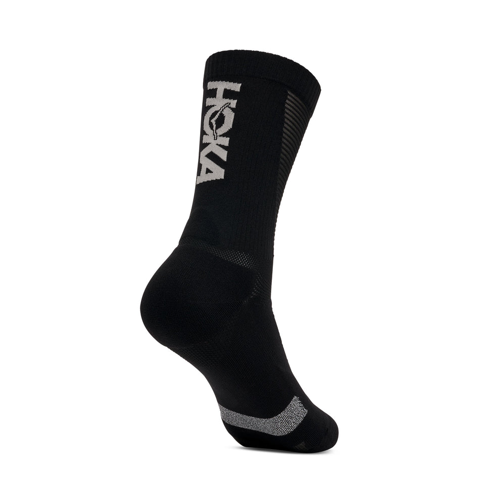 Angled view of one of the socks from a pair of HOKA Unisex Race Day Crew Sock in the Black colourway.