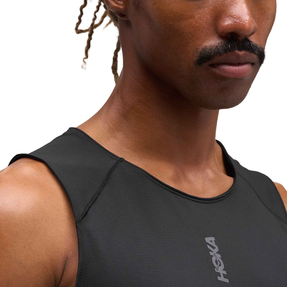 Front view of a model wearing the HOKA Men's Everyrun Tank in the Black colourway.