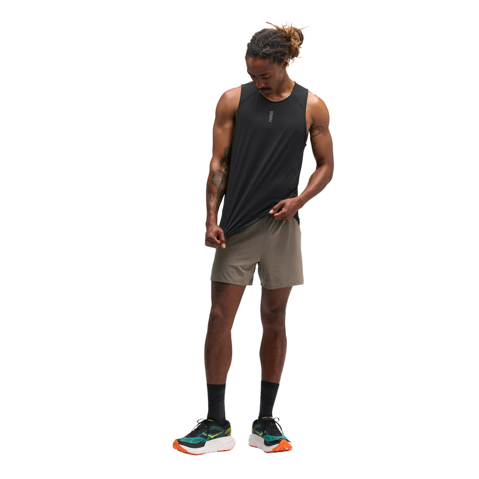 Front view of a model wearing the HOKA Men's Everyrun Tank in the Black colourway.