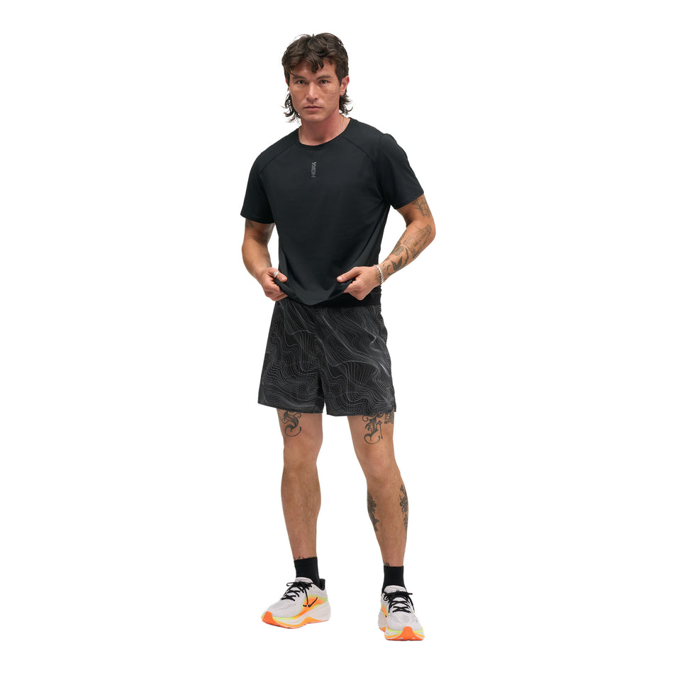 Front view of a model wearing the HOKA Men's Everyrun Short Sleeve in the Black colourway.