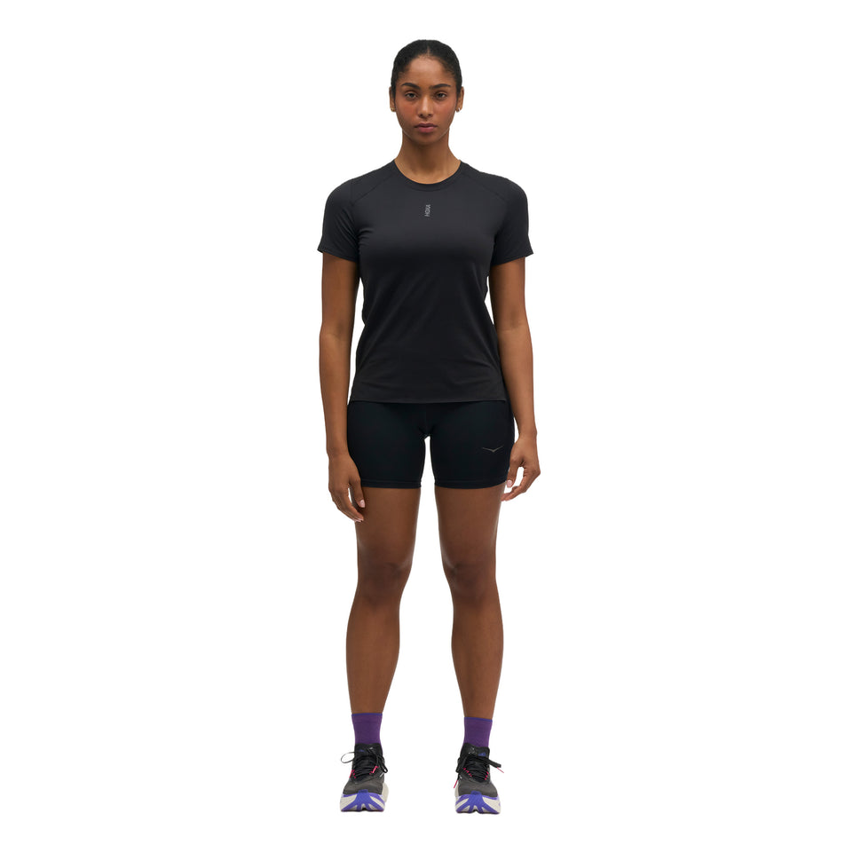 Front view of a model wearing the HOKA Women's Everyrun Short Sleeve in the Black colourway.