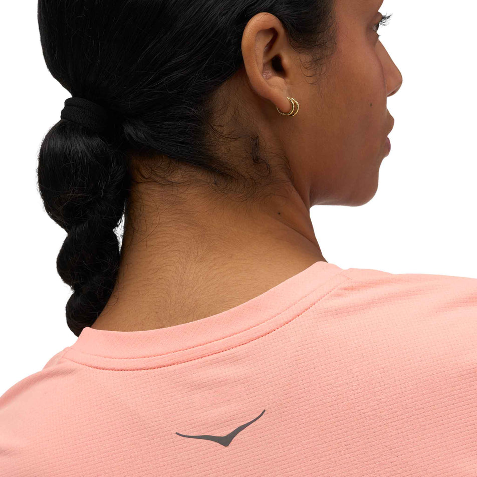 Back view of a model wearing the HOKA Women's Everyrun Short Sleeve in the Sunstone colourway.