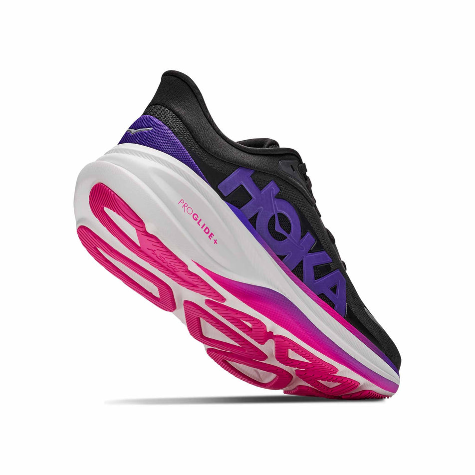 Lateral - and outsole - view of the right shoe from a pair of HOKA Women's Clifton Pro Running Shoes in the Carbon Black/Cosmic Purple colourway.