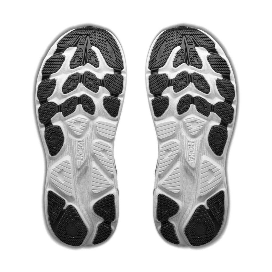 The outsoles of a pair of HOKA Women's Clifton 11 Running Shoes in the Black/White colourway.