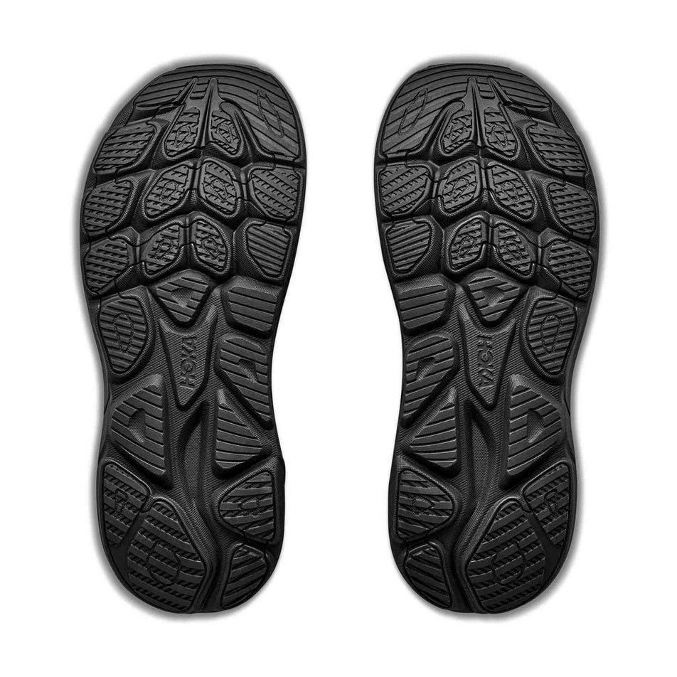 The outsoles of a pair of HOKA Women's Clifton 11 GTX Running Shoes in the Black/Black colourway.