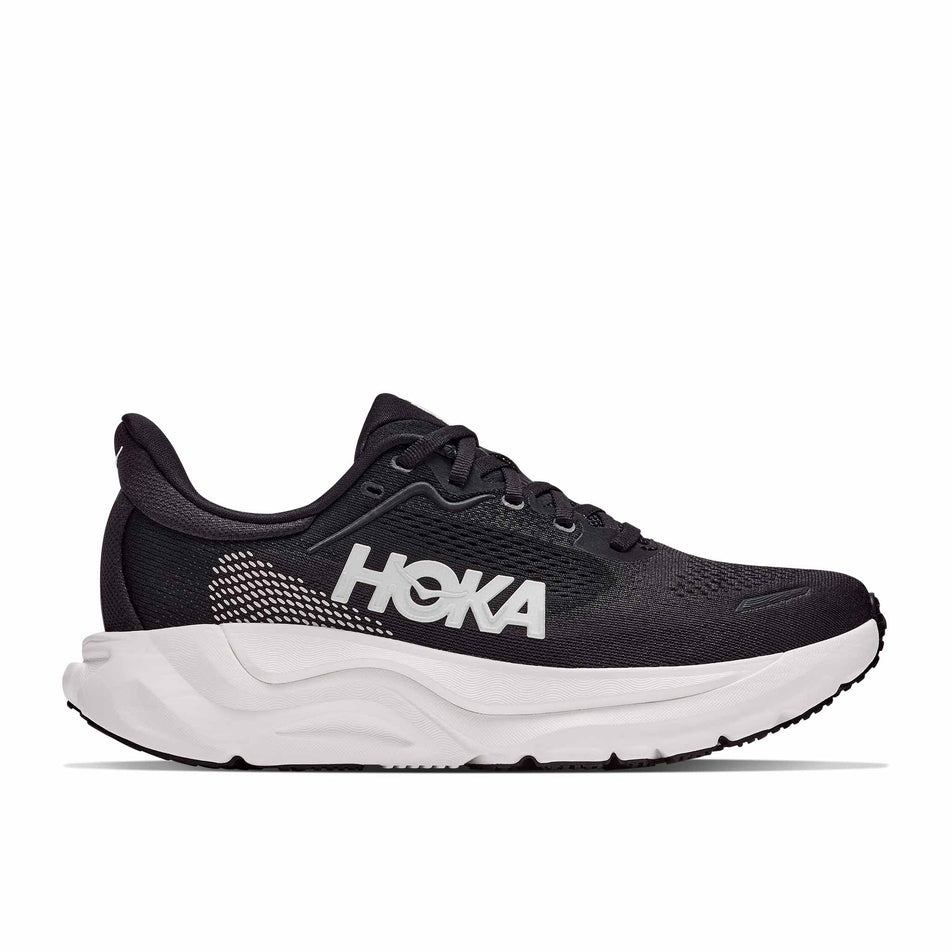 Lateral view of the right shoe from a pair of HOKA Men's Arahi 9 Wide Running Shoes in the Black/White colourway.