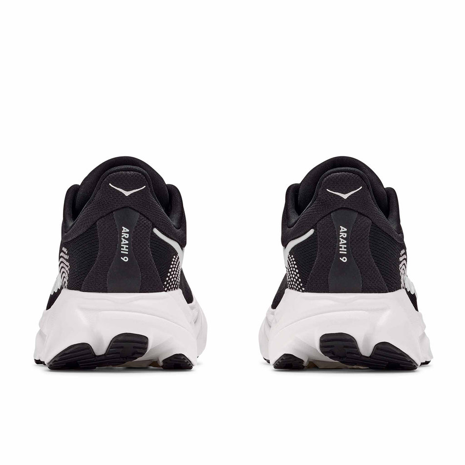 The back of a pair of HOKA Men's Arahi 9 Wide Running Shoes in the Black/White colourway.