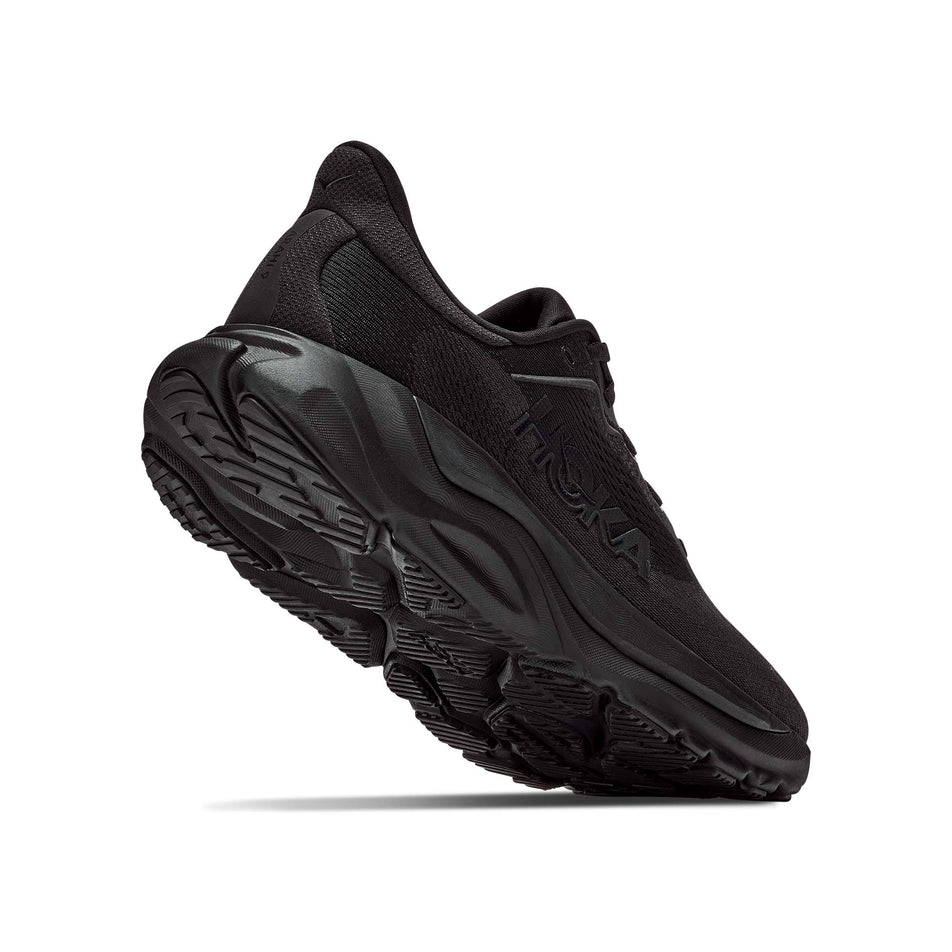 Lateral - and outsole - view of the right shoe from a pair of HOKA Women's Arahi 9 Wide Running Shoes in the Black/Black colourway.
