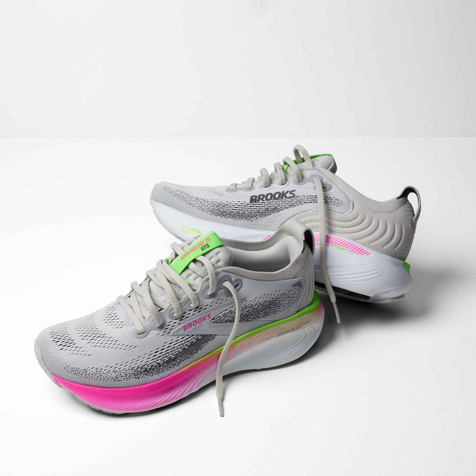 A pair of Brooks Women's Adrenaline GTS 25 1D Running Shoes in the Oyster/Pink/Green colourway.
