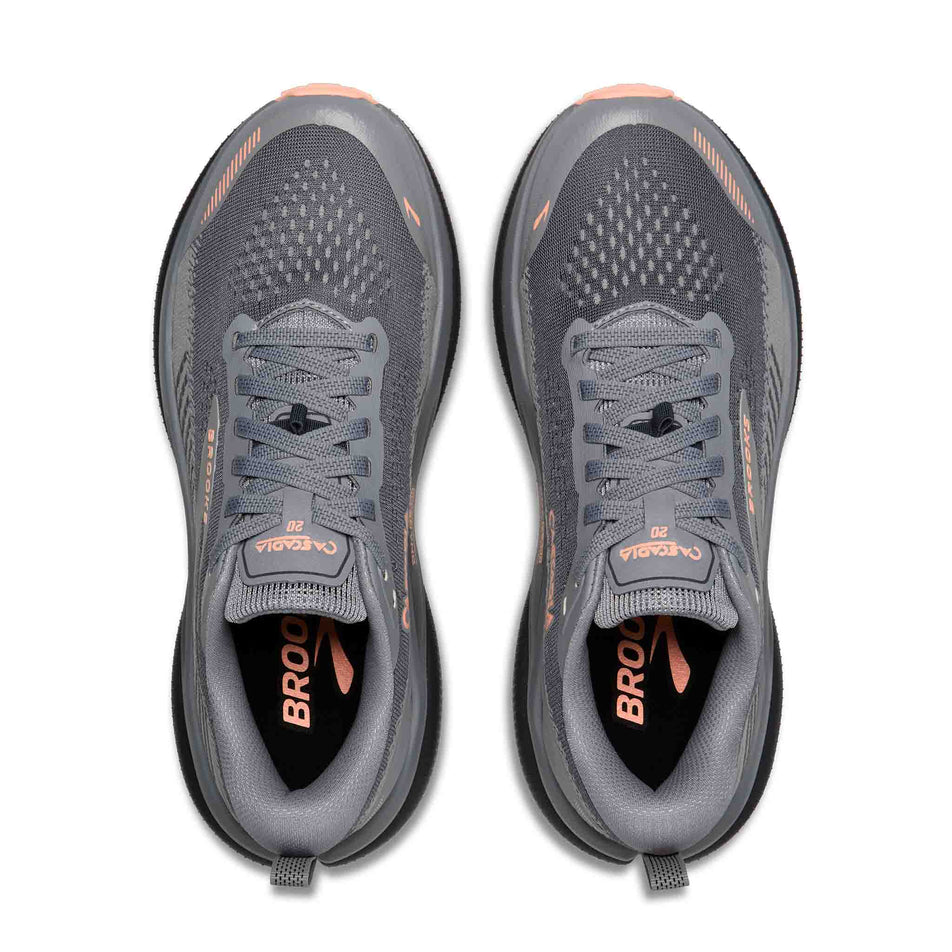 The uppers of a pair of Brooks Women's Cascadia 20 Running Shoes in the Grey/Grey/Peach colourway.