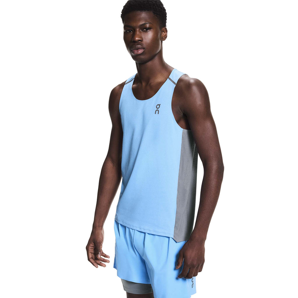 Angled view of a model wearing the On Men's Performance Tank in the Gourami/Rock colourway.